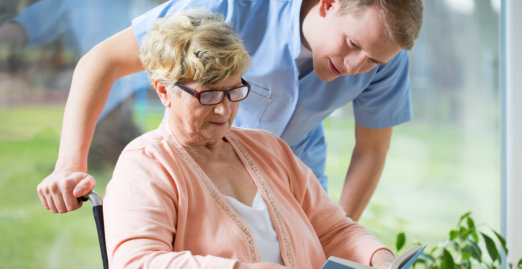 portrait of nurse and his patient on wheelchair