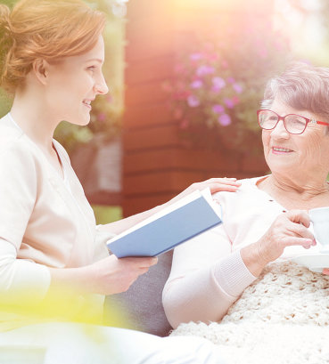 caregiver holding a book with his patient